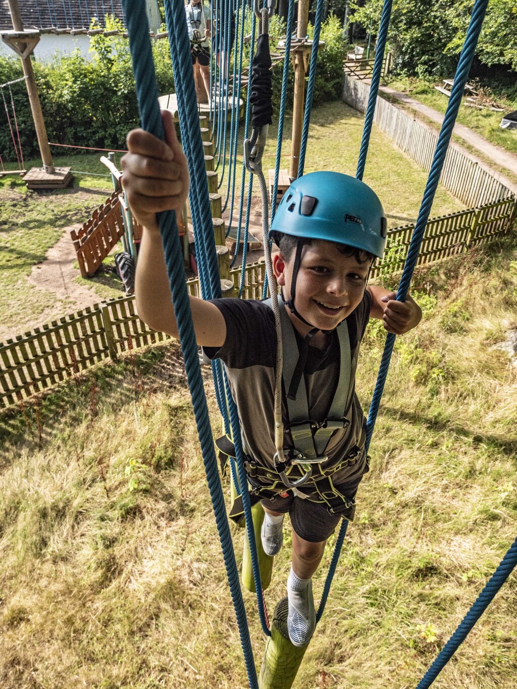 A young boy on the high ropes course at St Fagans 