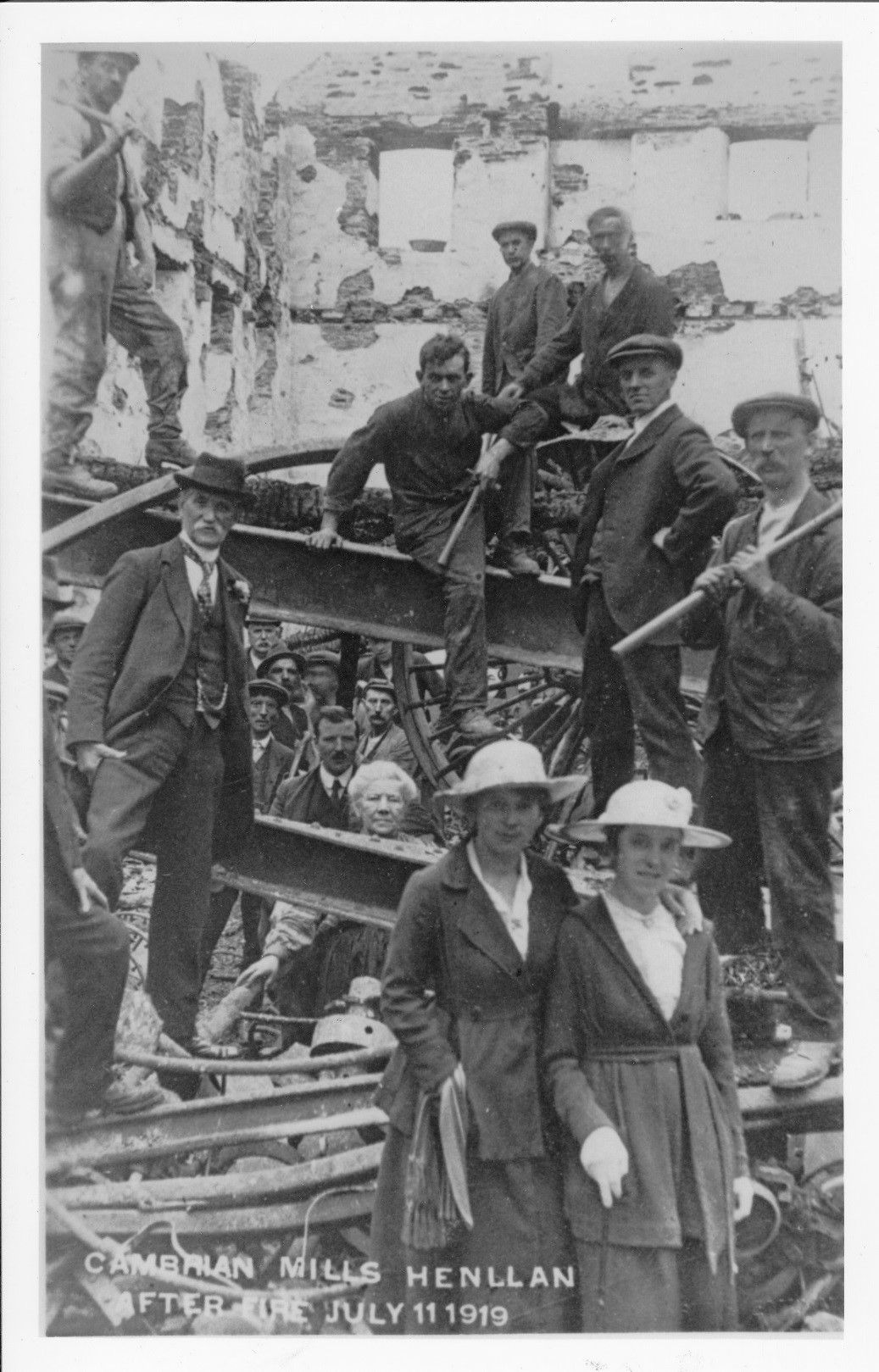 David Lewis on the left of the photograph with the moustache and hat in the remains of Cambrian Mills